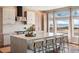 Modern kitchen featuring a large island with seating, stylish cabinetry, and bright natural light at 1658 Glade Gulch Rd, Castle Rock, CO 80104