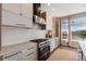 Bright kitchen with stainless appliances, white backsplash and modern gas range at 1658 Glade Gulch Rd, Castle Rock, CO 80104