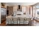 Well-lit kitchen with modern stainless steel appliances, a large island, and stylish counter seating at 1658 Glade Gulch Rd, Castle Rock, CO 80104