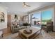 Bright living room featuring an open layout, stylish furniture, and sliding glass doors leading to a deck at 1658 Glade Gulch Rd, Castle Rock, CO 80104