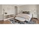 Comfortable bedroom with a upholstered bed, hardwood floors and natural light at 1658 Glade Gulch Rd, Castle Rock, CO 80104