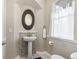 Well-lit powder room features modern fixtures, a stylish mirror, and a decorative mosaic backsplash for a touch of elegance at 1658 Glade Gulch Rd, Castle Rock, CO 80104