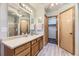 Bathroom featuring wood cabinets, modern fixtures and bright lighting at 2209 S Flanders St, Aurora, CO 80013