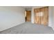 Bedroom with carpet flooring, closet, and doorway to the bathroom at 2209 S Flanders St, Aurora, CO 80013