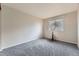 Bedroom features a plush carpet and window that provides ample natural light at 2209 S Flanders St, Aurora, CO 80013