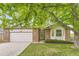 Charming single-story brick home featuring an attached two-car garage and well-maintained front lawn at 2209 S Flanders St, Aurora, CO 80013