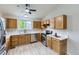 Bright kitchen features stainless appliances, white countertops and wood cabinets at 2209 S Flanders St, Aurora, CO 80013