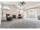 Cozy living room with carpet flooring, fireplace, large windows and high ceilings at 2209 S Flanders St, Aurora, CO 80013