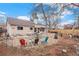 Backyard featuring a gravel area, covered patio, fire pit, and fencing, creating an outdoor living space at 16084 E Lehigh Cir, Aurora, CO 80013