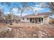 Backyard with a gravel area, covered patio, fire pit, and fencing, creating an outdoor living space at 16084 E Lehigh Cir, Aurora, CO 80013