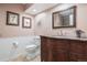 Cozy bathroom with tiled floor, wood vanity with granite countertop, and modern fixtures at 16084 E Lehigh Cir, Aurora, CO 80013