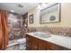 Stylish bathroom with a tiled shower, unique sink, and mirror, blending functionality and design at 16084 E Lehigh Cir, Aurora, CO 80013