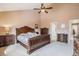 A bedroom features a luxurious bed frame, neutral carpet and walls, with coordinated side tables at 16084 E Lehigh Cir, Aurora, CO 80013