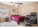 Cozy bedroom with a ceiling fan, window with blinds, and a comfortable armchair at 16084 E Lehigh Cir, Aurora, CO 80013