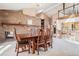 Elegant dining room featuring a full brick wall, spacious table with seating for eight, and modern chandelier at 16084 E Lehigh Cir, Aurora, CO 80013