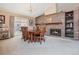 Open dining room with brick fireplace, chandelier, and sliding glass door to the patio at 16084 E Lehigh Cir, Aurora, CO 80013