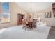 Dining area with large windows and sliding glass door allowing for bright natural light at 16084 E Lehigh Cir, Aurora, CO 80013