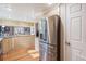 Spacious kitchen with stainless steel refrigerator and granite countertops, great for cooking at 16084 E Lehigh Cir, Aurora, CO 80013