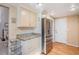Kitchen with stainless steel refrigerator, granite countertops and plenty of storage at 16084 E Lehigh Cir, Aurora, CO 80013