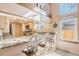 Kitchen breakfast bar, with granite countertops, seating and bright natural light at 16084 E Lehigh Cir, Aurora, CO 80013