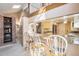 Breakfast bar area with marble countertops and seating, open to a kitchen at 16084 E Lehigh Cir, Aurora, CO 80013