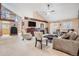 Open-concept living room boasting vaulted ceilings, exposed beams, and a cozy fireplace at 16084 E Lehigh Cir, Aurora, CO 80013