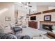 Spacious living room with vaulted ceilings, brick fireplace, and large windows for abundant natural light at 16084 E Lehigh Cir, Aurora, CO 80013