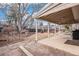 Covered patio with stone pavers, gravel area, and seating, perfect for relaxation and entertainment at 16084 E Lehigh Cir, Aurora, CO 80013