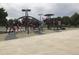 Community playground with a range of climbing structures, slides, and shaded areas for play at 16084 E Lehigh Cir, Aurora, CO 80013