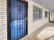 Apartment building entryway with a blue security door at 1723 Robb St # 31, Lakewood, CO 80215