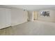 Living area with grey carpet and entry to kitchen at 1723 Robb St # 31, Lakewood, CO 80215