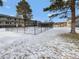 Fenced-in pool area with snowy ground at 1723 Robb St # 31, Lakewood, CO 80215