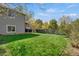 A sprawling backyard featuring a lush lawn, partial fence and mature trees that provides privacy at 5566 S Zinnia St, Littleton, CO 80127