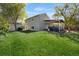 Spacious backyard with a well-maintained lawn and a covered patio perfect for outdoor entertaining at 5566 S Zinnia St, Littleton, CO 80127