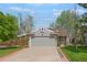 Charming home featuring a gray exterior, well-manicured lawn, and an attached two-car garage at 5566 S Zinnia St, Littleton, CO 80127