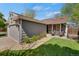 Charming home featuring an attached garage and cozy front patio area with seating at 5566 S Zinnia St, Littleton, CO 80127