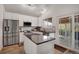 Bright kitchen featuring white cabinets, granite counters, stainless steel appliances, and backyard access at 5566 S Zinnia St, Littleton, CO 80127
