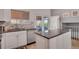 Bright kitchen featuring granite countertops, white cabinetry, stainless steel appliances, and backyard access at 5566 S Zinnia St, Littleton, CO 80127