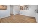 Open-concept living room featuring wood flooring and a staircase with wood and black iron railings at 5566 S Zinnia St, Littleton, CO 80127