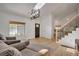 Bright living room featuring hardwood floors, a large window, and a staircase with iron railings at 5566 S Zinnia St, Littleton, CO 80127
