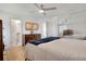 Serene main bedroom featuring a ceiling fan, wood floors, television, and a mirrored closet at 5566 S Zinnia St, Littleton, CO 80127