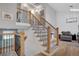 Bright staircase with wood and black iron railings, carpet treads, and natural light at 5566 S Zinnia St, Littleton, CO 80127