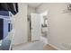 Walk-in closet leading to a bright bathroom with a soaking tub at 18220 W 84Th Pl, Arvada, CO 80007