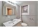 Bathroom featuring a large sink, a mirror, and a toilet with tiled floors at 2607 E 14Th Ave, Denver, CO 80206