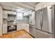 Efficient kitchen featuring stainless steel appliances, white cabinets, and modern countertops at 2607 E 14Th Ave, Denver, CO 80206