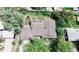 An aerial view of a single-Gathering home featuring a large backyard with mature trees and a well-maintained roof at 962 S Beech St, Lakewood, CO 80228