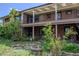 Two-story brick house with a balcony, a patio, and a partially shaded area at 962 S Beech St, Lakewood, CO 80228