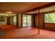 Basement featuring a fireplace, wood paneling, and natural lighting at 962 S Beech St, Lakewood, CO 80228
