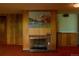 Basement with a brick fireplace, wood paneling, and vintage details at 962 S Beech St, Lakewood, CO 80228