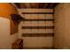 Unfinished basement with wooden shelves offering potential storage space at 962 S Beech St, Lakewood, CO 80228
